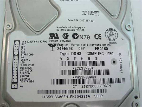 Compaq 313708-001 rating plate label showing IBM 59H6606 part number, manufacture date 24FEB98, firmware FR01B0, +12V/+5V power ratings, and Singapore origin
