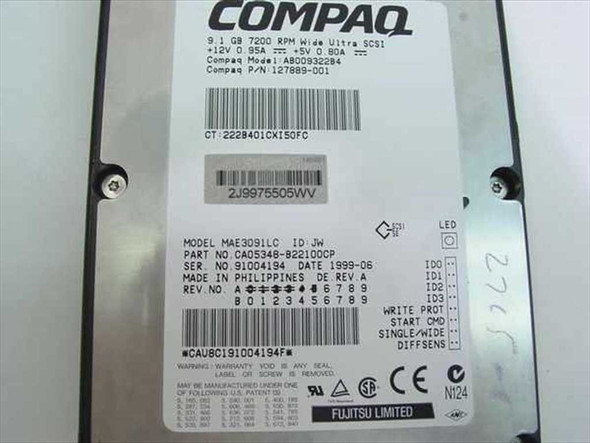 Compaq 127889-001 drive label close-up showing 9.1GB 7200RPM Wide Ultra SCSI specs, Fujitsu MAE3091LC model, part number CA05348-B221DCCP, and manufacture date 1999-06