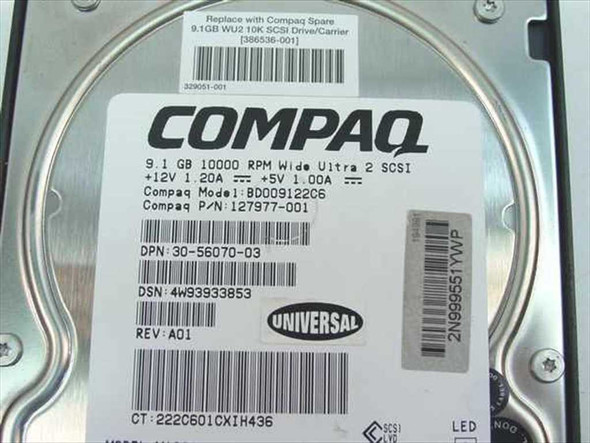 Compaq 127977-001 drive label close-up showing model BD009122C6, 9.1GB 10000 RPM Wide Ultra2 SCSI, +12V 1.20A +5V 1.00A, P/N 127977-001, REV A01