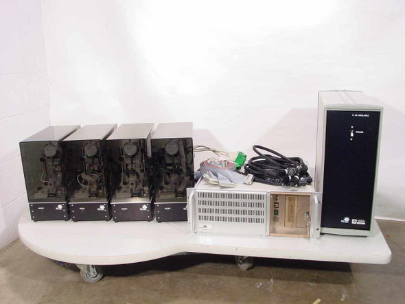 Lotus Technologies 7100 CSS Hard Drive Tester System – full system overview showing 4 tester modules, rack computer unit, and tower controller on table with cables