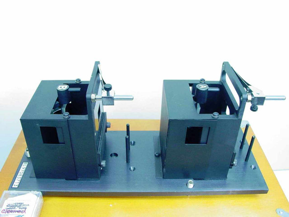 Applied Magnetics EL97083713 dual alignment fixture modules on yellow base plate — front view out of case, accessories visible at left
