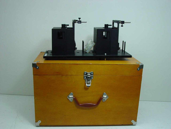 Applied Magnetics EL97083713 AB Alignment Assembly mounted on base plate, resting on top of closed wooden carrying case — front view