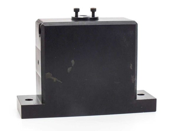45-degree aluminum optics block rear/side view showing anodized black finish with visible surface scuffs and two base mounting holes