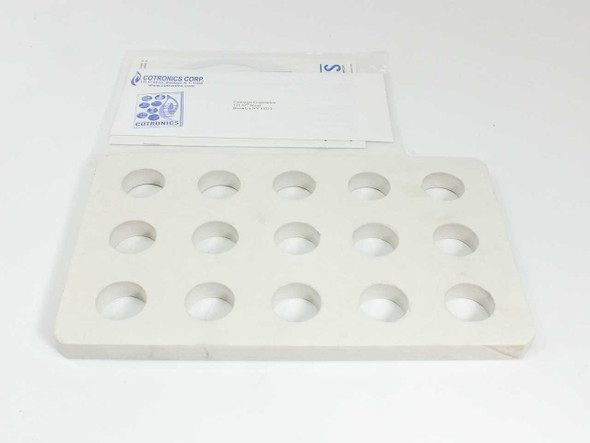 Cotronics ceramic plate 12x7.25x0.625 in with 15 machined 1.25 in diameter holes — top view with original Cotronics Corp packaging envelope