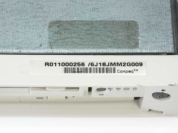 Compaq ProLiant DL320 label close-up showing part number R0011000256 and serial barcode 6J18JMM2G009
