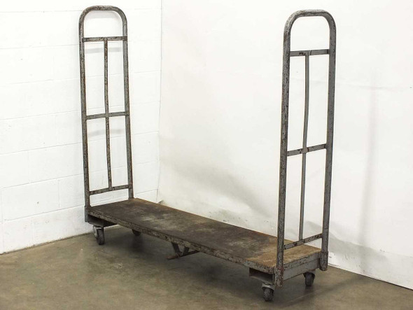Industrial steel utility delivery cart with dual removable upright handle frames and flat deck platform on caster wheels — front three-quarter view