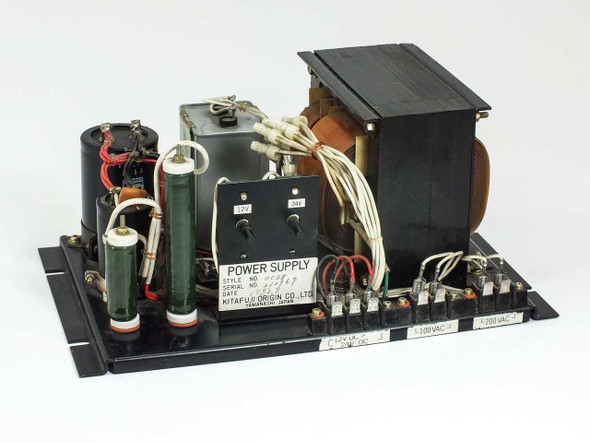 Kitafuji Origin 0038 open-frame AC-to-DC power supply – three-quarter front view showing transformer, capacitors, and terminal block