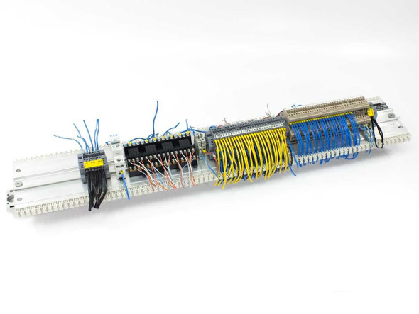 Full DIN rail assembly with terminal blocks, relay cards, Eaton breaker, and wiring installed – overhead angle view