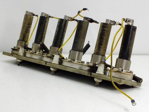 Solitron 7846 C664 solid state rectifier assembly — side angle view showing all 6 units with yellow lead wires and ceramic base sockets on PCB