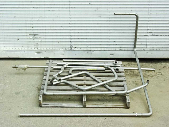 Stainless steel pipe lot overview on pallet – straight pipes, bent sections, and tall upright pipe visible