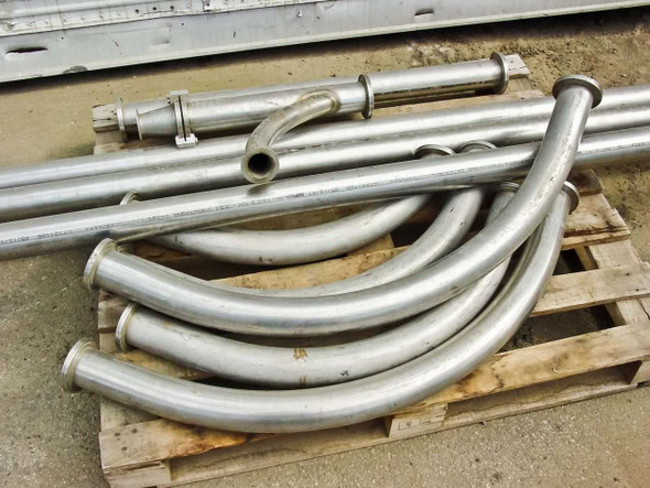 Overhead view of stainless steel pipe lot showing mix of straight pipes and multiple curved bend sections on pallet