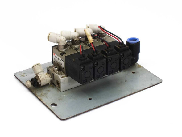 SMC VK332-5G-01 solenoid valve manifold – angled front-right view showing four valve bodies, push-in tube fittings, and lead wires
