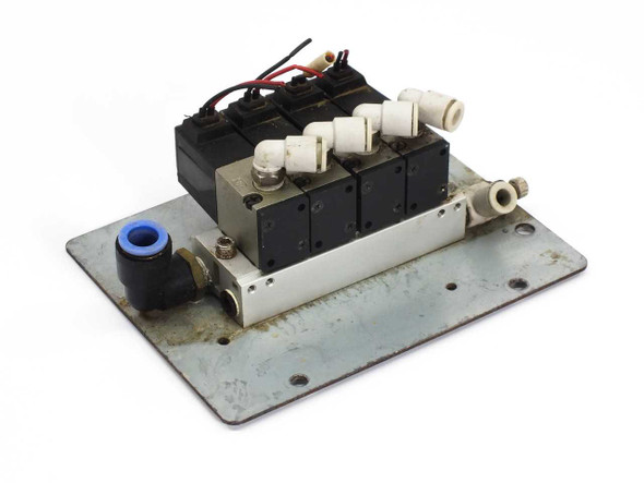 SMC VK332-5G-01 pneumatic solenoid valve manifold – four valves mounted on metal plate, angled front-left view showing push-in fittings and wiring