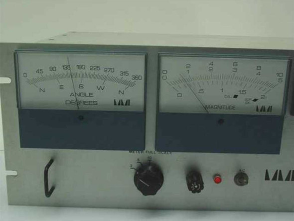 Marsh-McBirney Model 500 front panel close-up — left meter shows Angle in Degrees (0–360, N/E/S/W), right meter shows Magnitude scale, red indicator light and rotary selector visible
