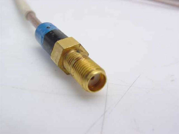 Close-up of gold-plated SMA Female connector end with blue and black heat shrink strain relief on Times Microwave RF cable
