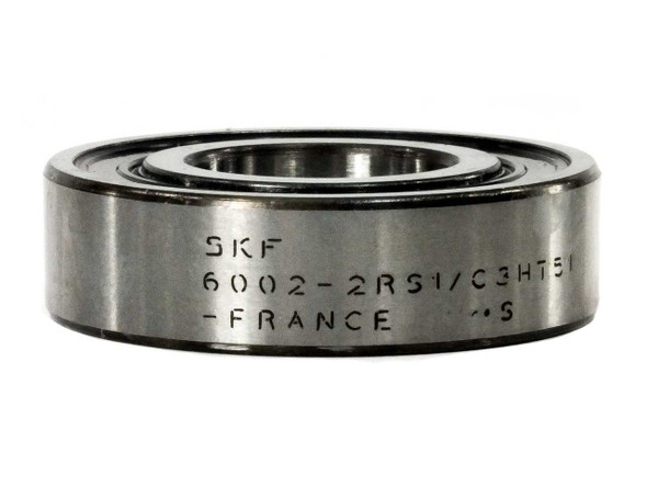 SKF 6002-2RS1/C3HT51 deep groove ball bearing removed from box — side profile showing double rubber seals, stamped markings visible