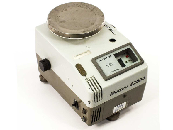 Mettler E2000 2kg analytical gram scale – front-right three-quarter view showing circular pan and analog display