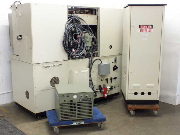 MRC 603-III sputtering system rear view with wiring harness exposed, high-voltage power cabinet visible, CTI cryopump compressor on dolly
