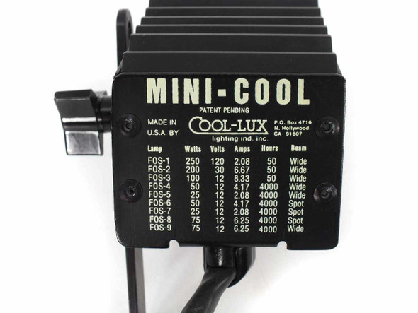 Cool-Lux Mini-Cool spotlight — side label showing brand name, patent pending notice, Made in USA, and FOS lamp compatibility chart with wattage, voltage, amps, and hours