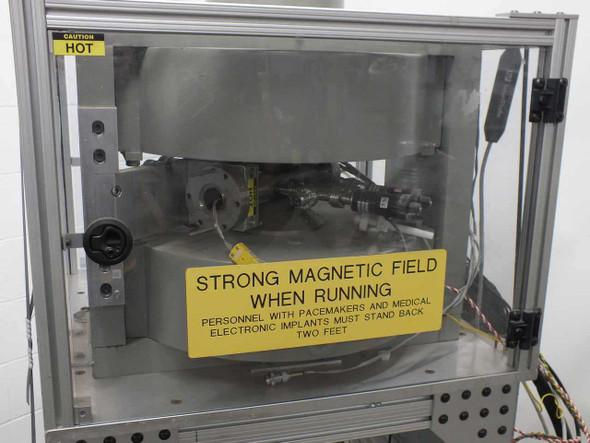 LDJ Electronics 6007 electromagnet close-up showing large circular pole cap assembly with strong magnetic field warning label and Caution Hot notice