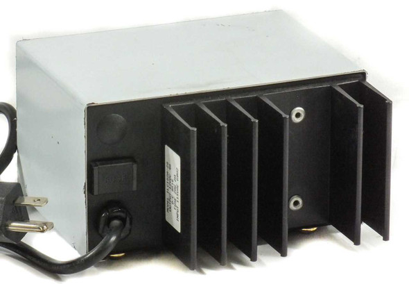 Xenotronix 1LC162A-29 battery charger – rear/side view showing large aluminum heat sink fins and attached AC power cord with NEMA plug