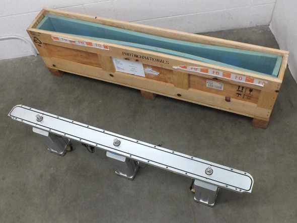 VAT X-VAT100-40496 stainless steel vacuum valve port assembly laid alongside open wooden shipping crate lined with foam padding, top-down view