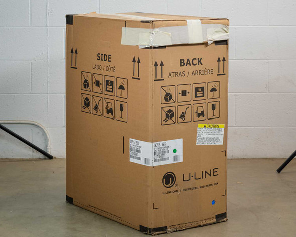 U-Line UHCP115-BS01A 15" clear ice machine in original shipping box — back and side panels visible with U-Line branding