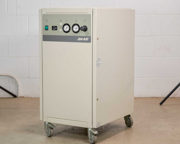 Jun-Air 2000-25M oil-free cabinet air compressor – three-quarter front-left view showing enclosed cream cabinet with casters