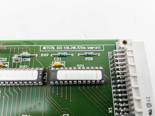 Netstal DIO 110.240.9216A Komplett label close-up on PCB with visible component designations R49, C21, R50 and DIP ICs