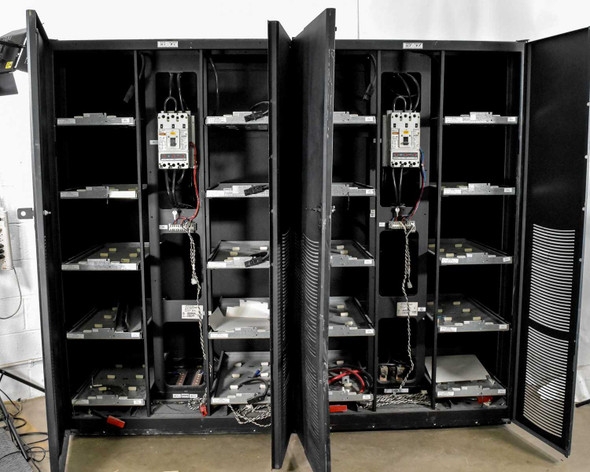 Eaton 9390 battery cabinets open front view showing empty B47 battery trays and HKD-DC DC circuit breakers installed