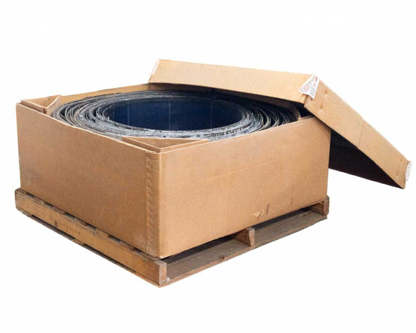 Close-up of Uni-Solar PVL-116 panels coiled inside open cardboard box showing panel edges and MC3 cable loop visible