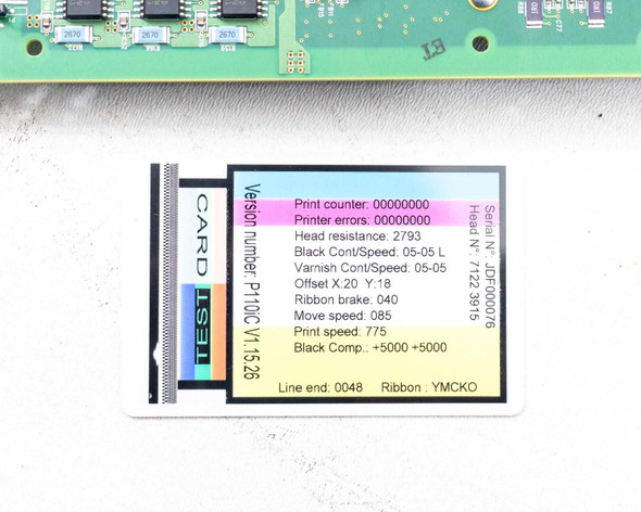 Zebra P110i 404720-001P board — close-up of calibration test card showing firmware version P110C V1.5.26 and printer configuration data