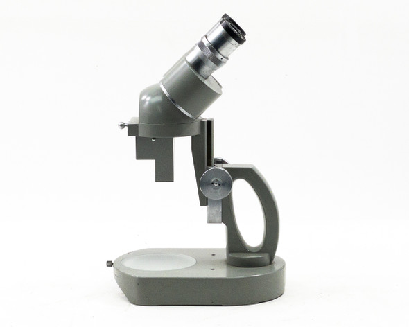 Elgeet No. 56896 stereo microscope right-side profile view showing arm, focus knob, and base with stage disc