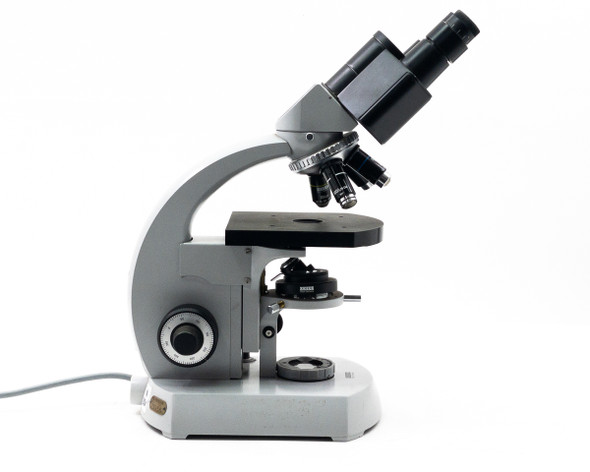 Carl Zeiss 470916-9902 binocular microscope left-side view showing coarse and fine focus knobs and condenser
