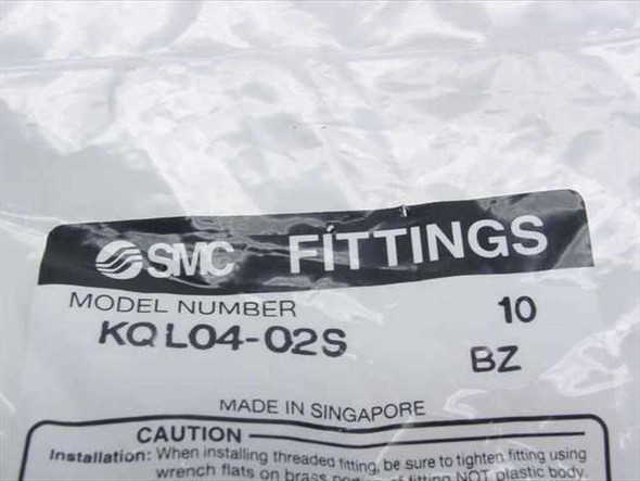 SMC Fittings label closeup showing model number KQL04-02S, quantity 10, BZ designation, Made in Singapore, with caution installation instructions