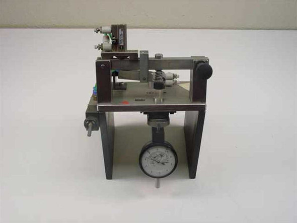 SMC pneumatic tolerance checking fixture front view showing analog dial indicator gauge mounted below linear slide assembly