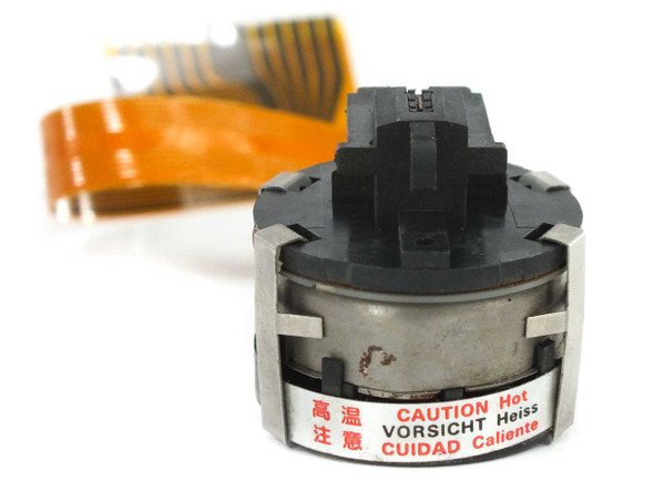 Citizen IDP-3500 print head close-up showing cylindrical head body with caution hot label and metal retaining clips