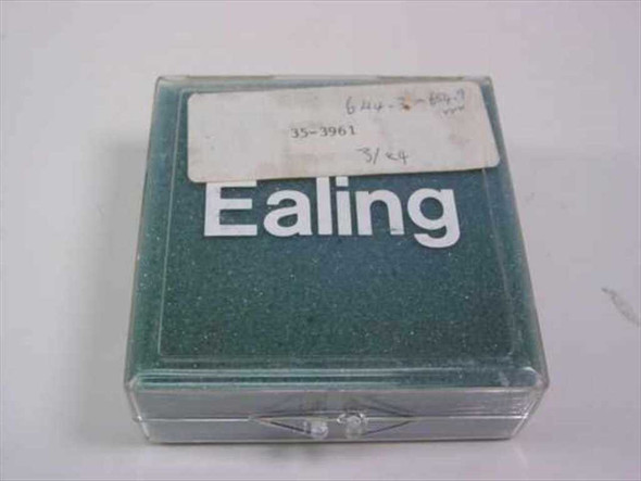 Ealing Corp 35-3961 dielectric bandpass filter in original plastic clamshell storage case, closed, with handwritten label showing part number and specs