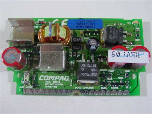 Compaq 169317-001 Voltage Regulator Module front side showing DC/DC converter label, toroidal inductor, red capacitors, and 12V input redundant sticker