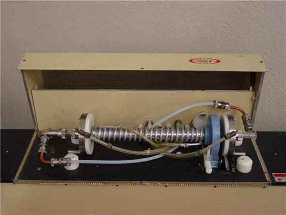 Phase-R laser system with enclosure open showing internal pulsed laser tube, helical coil assembly, water cooling lines, and optical components