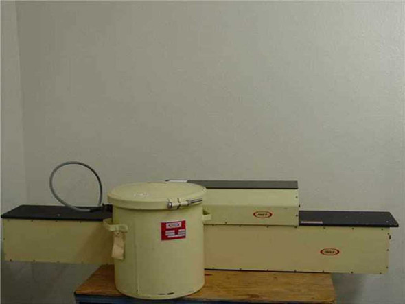 Phase-R Phased-Radiation 20mW pulsed laser system with cylindrical laser head and elongated power supply enclosure on workbench — overall view