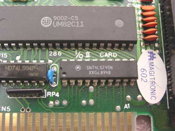 Close-up of Magitronic B231 ISA card PCB showing UMC UM82C11 main controller chip and Motorola SN74LS245N IC with board silkscreen reading 286 I/O II Card