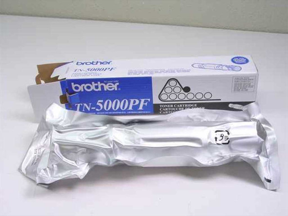 Brother TN-5000PF toner cartridge removed from box, sealed in original silver foil protective bag alongside the retail box