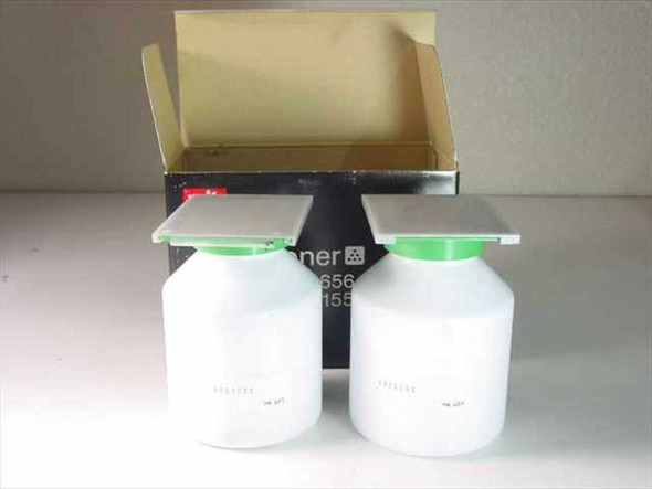 Mita 37046011 toner – two white 180g toner bottles with green caps removed from open box