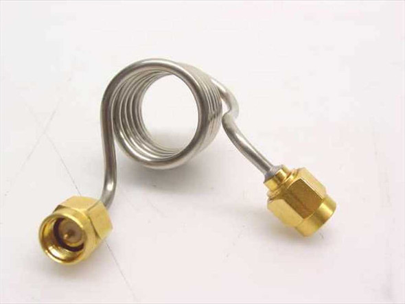 Unbranded stainless steel coiled coaxial cable with SMA male connectors on both ends – side view showing full coil and both gold connectors