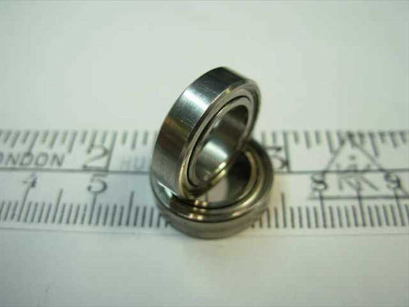 Steel double-shielded ball bearing 3/8 x 5/8 x 5/32 shown at angle next to ruler – side profile view
