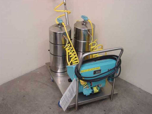 Metro-Line ML1000 oil pump cart – rear-right view showing dual stainless steel supply and waste tanks with yellow coiled hoses and control panel facing away