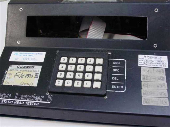 Conner Moon Lander II front panel showing hex keypad, ESC/SPC/DEL/ENTER keys, FilePro III label, and Applied Magnetics calibration stickers
