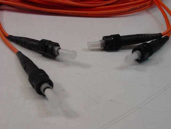 Close-up of both ST duplex connector pairs on the Siecor OFNR fiber optic cable showing ferrules and boots