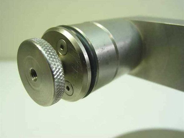Close-up of knurled cylindrical end fitting with O-ring seal groove on arm assembly